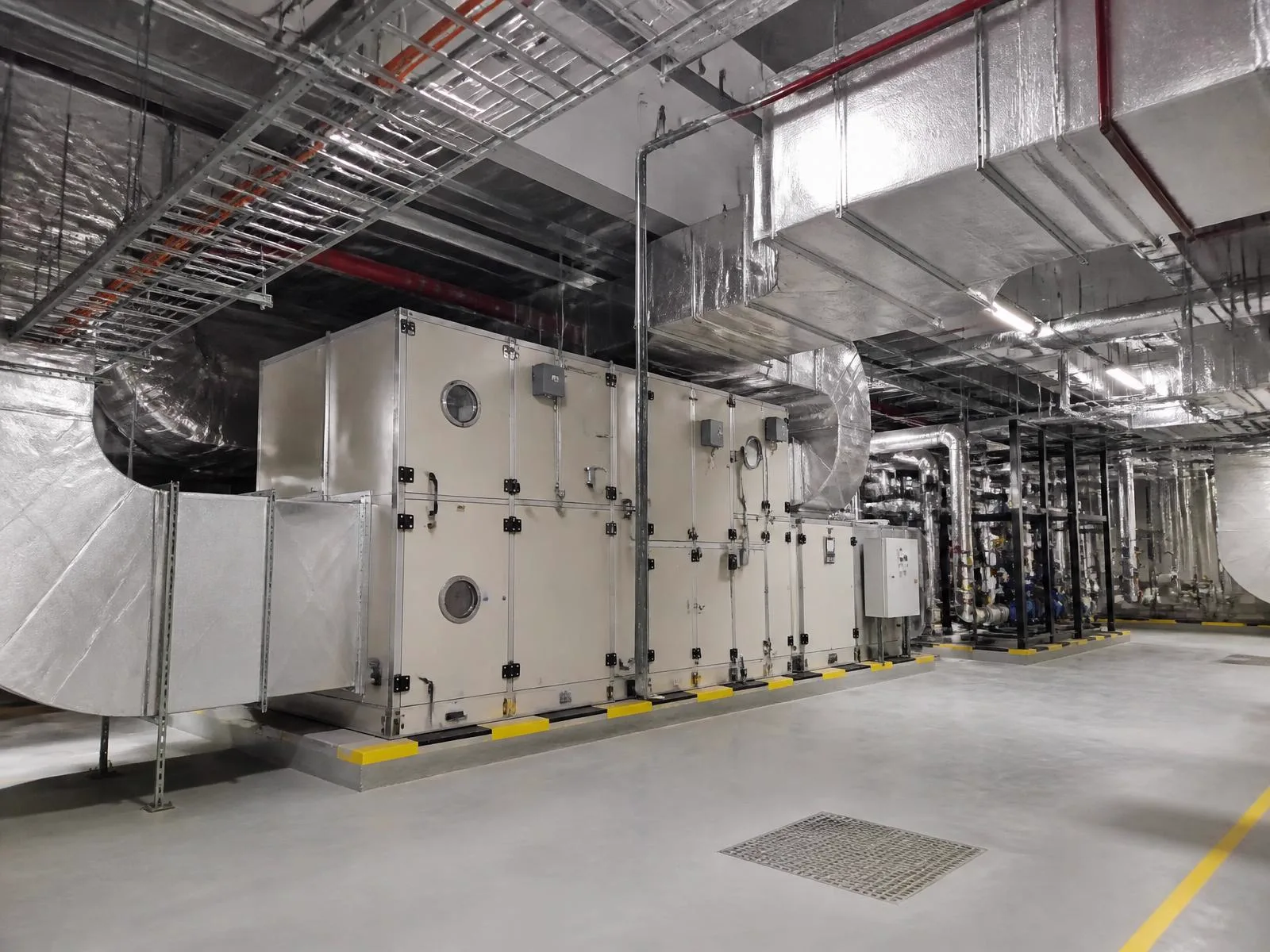 Completed commercial HVAC and ventilation installation with insulated ductwork and coordinated mechanical services.