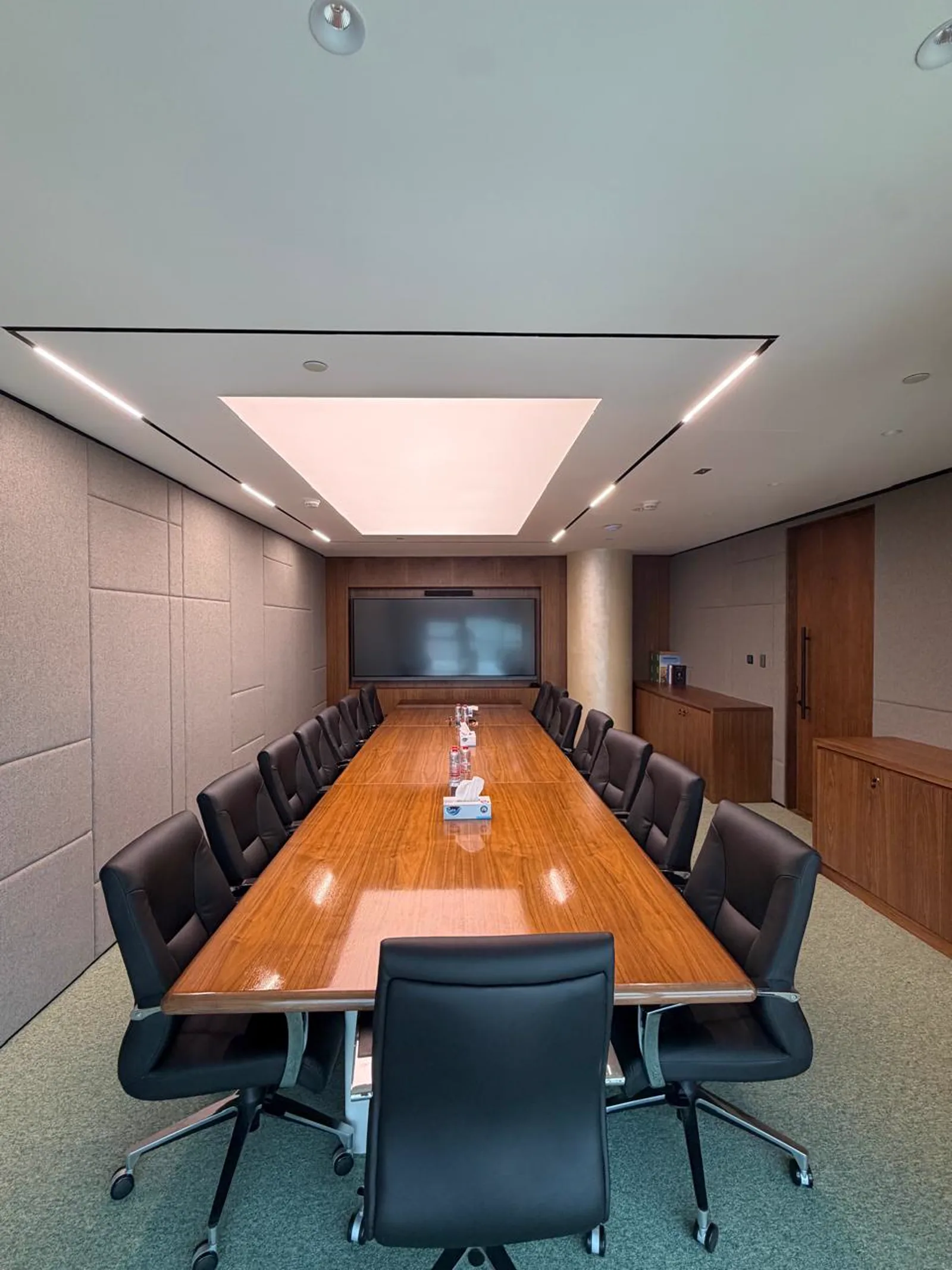 Executive conference room with acoustic wall panels, timber board table and backlit stretch ceiling