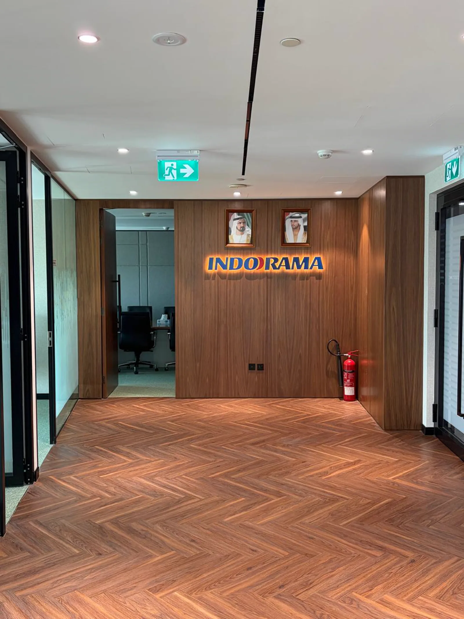 Indorama branding wall in walnut veneer at the completed office entrance lobby
