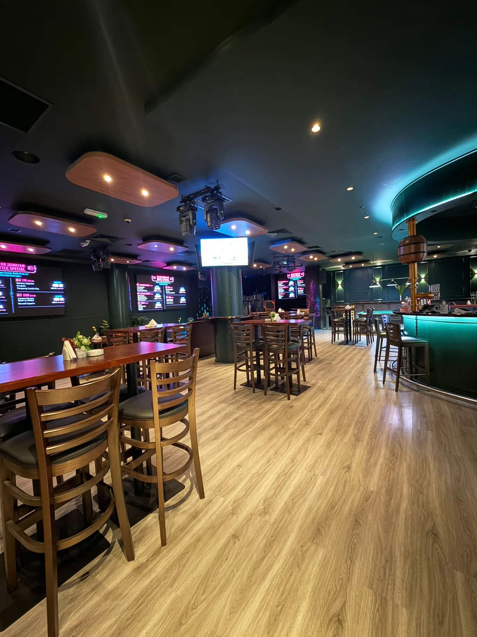 Completed Retox Bar & Lounge at Donatello Hotel with illuminated curved bar, high-top seating, timber flooring and wall-mounted display screens